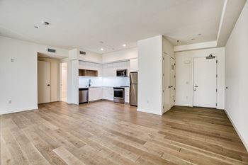 A spacious kitchen with a dining area and a living room.